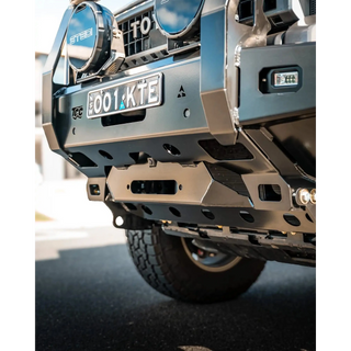 Close-up of a vehicle's front bumper with visible branding and license plate – TCC 250 Prado Bull Bar