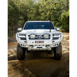 White Toyota SUV on a dirt road with trees in the background – TCC Toyota LandCruiser 300 Series Bull Bar