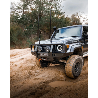 Toyota SUV driving on a dirt road with trees in the background – TCC 70 Series Bull Bar - Facelift (2024 - Present)