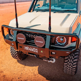 Front view of a Toyota vehicle on a dirt road – TCC 70 Series Bull Bar - Facelift (2024 - Present)
