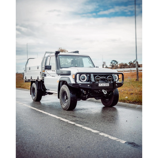 White Toyota truck on a road with a cloudy sky – TCC 70 Series Single Cab Bull Bar - Facelift (2024 - Present)