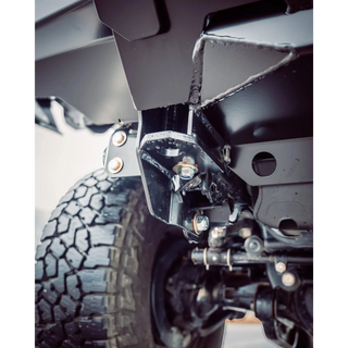 Close-up of a vehicle's suspension system with tire and undercarriage details – TCC 70 Series Single Cab Bull Bar - Facelift (2024 - Present)