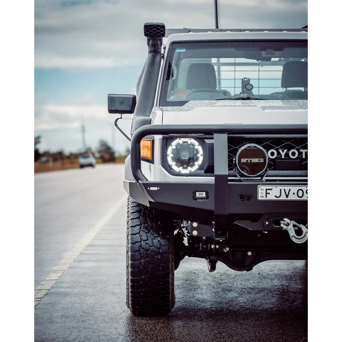 White off-road vehicle with custom modifications on a road – TCC 70 Series Single Cab Bull Bar - Facelift (2024 - Present)