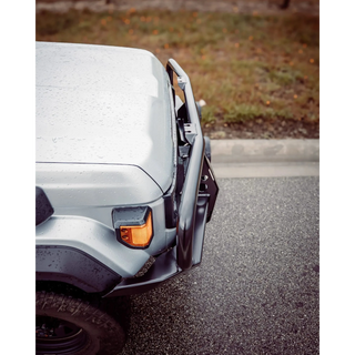 Close-up of a vehicle's front bumper and headlight on a road – TCC 70 Series Single Cab Bull Bar - Facelift (2024 - Present)