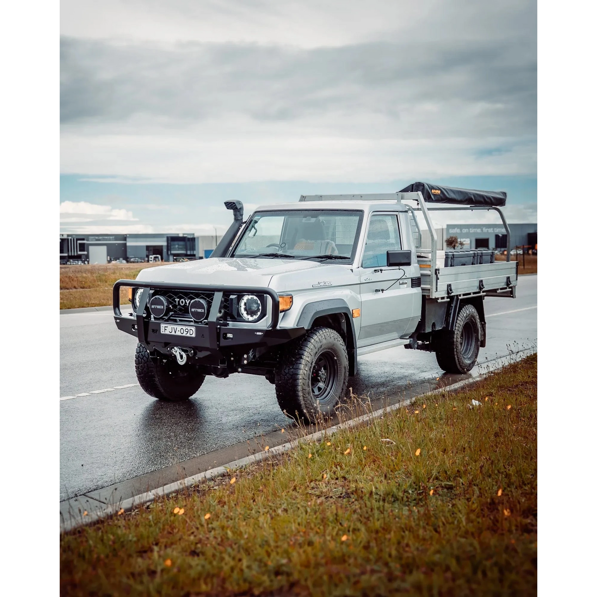 White Toyota truck on a wet road with a cloudy sky – TCC 70 Series Single Cab Bull Bar - Facelift (2024 - Present)