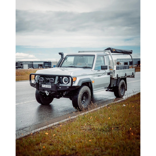 White Toyota truck on a wet road with a cloudy sky – TCC 70 Series Single Cab Bull Bar - Facelift (2024 - Present)