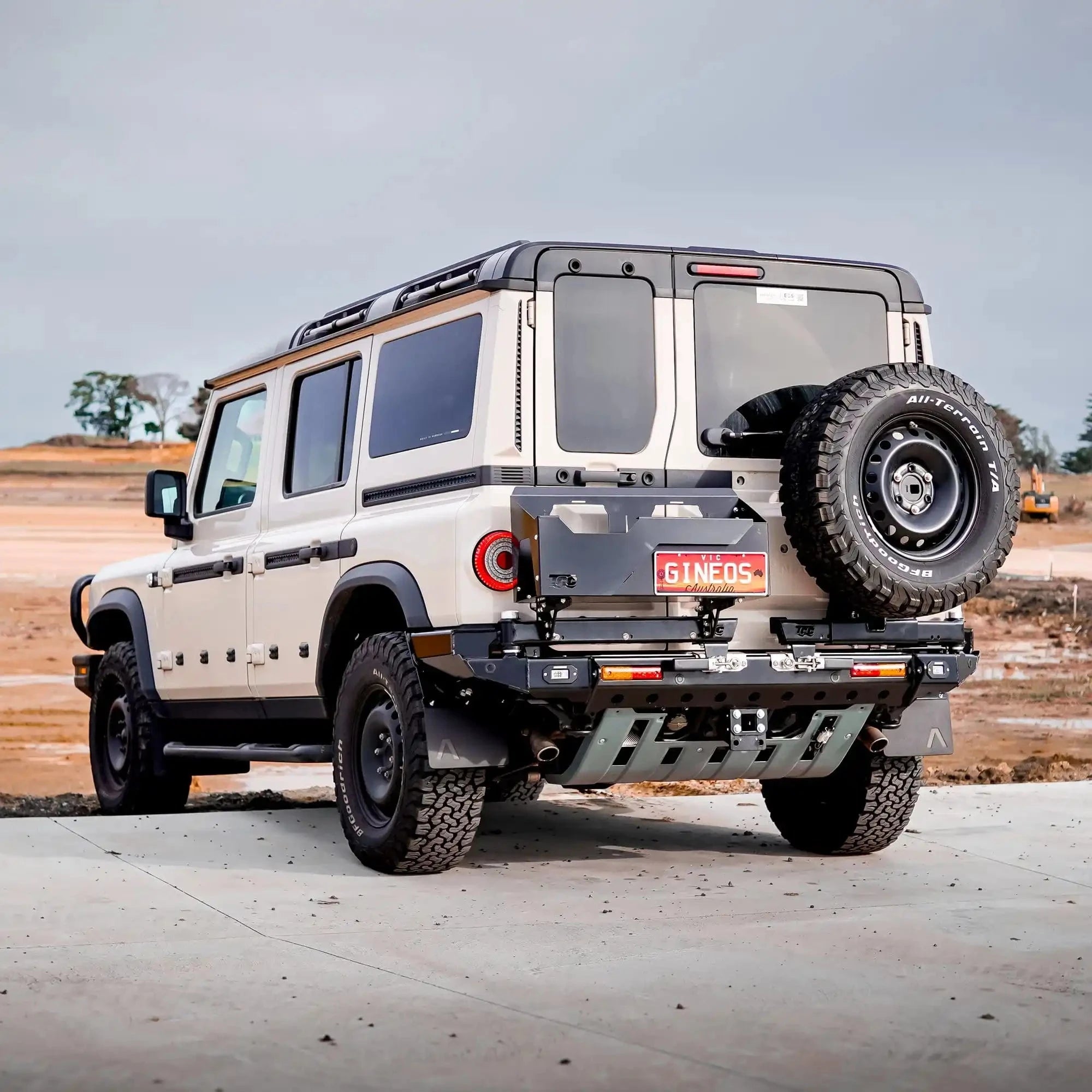 Off-road vehicle with large tires on a paved surface – TCC INEOS Grenadier Rear Bar