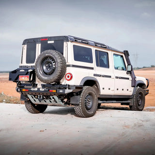 TCC INEOS Grenadier Rear Bar – white Grenadier with a spare tyre in a desert landscape
