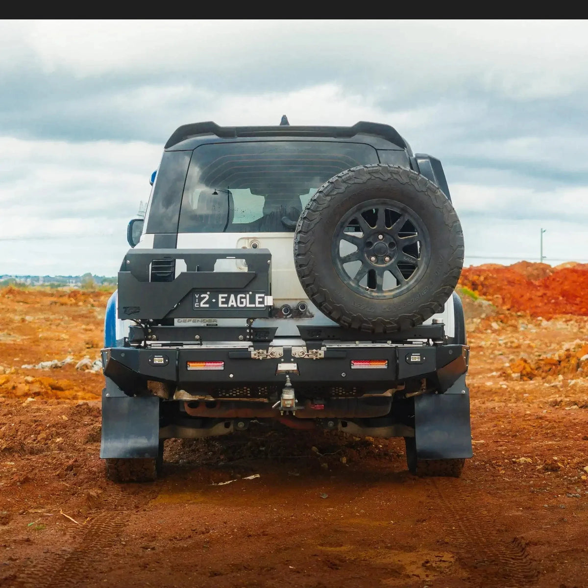 TCC Land Rover Defender 2020+ Rear Bar fitted, rear view on a dirt road