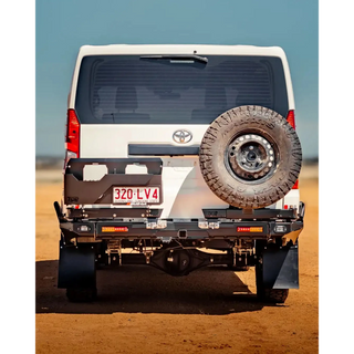 Back view of a white Toyota vehicle with a spare tire on a desert landscape – TCC Toyota Hiace 300 Series Rear Bar