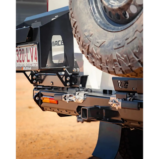 Close-up of a vehicle's hitch receiver with a tire in the background – TCC Toyota Hiace 300 Series Rear Bar