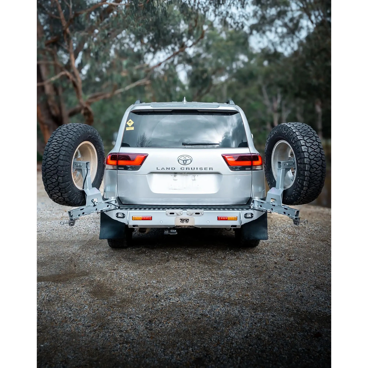 Toyota Land Cruiser with a spare tire mounted in a forest setting – TCC Toyota LC300 Series Rear Bar