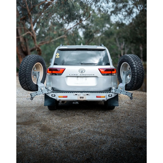 Toyota Land Cruiser with a spare tire mounted in a forest setting – TCC Toyota LC300 Series Rear Bar