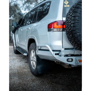 Silver SUV with off-road tire and bumper on a gravel surface – TCC Toyota LC300 Series Rear Bar