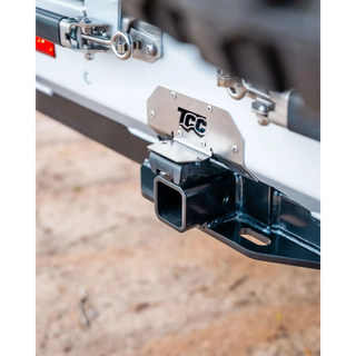 TCC hitch receiver on a vehicle with a blurred background – TCC Y62 Patrol Rear Bar