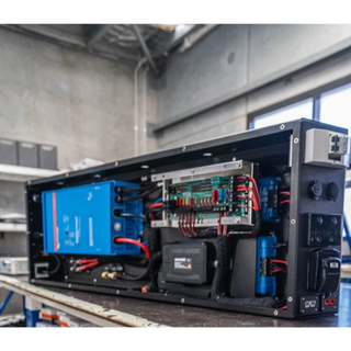 The Prospector with its cover off, showing the Victron inverter, EGON DC Hub, solar regulator and internal wiring laid out in the housing