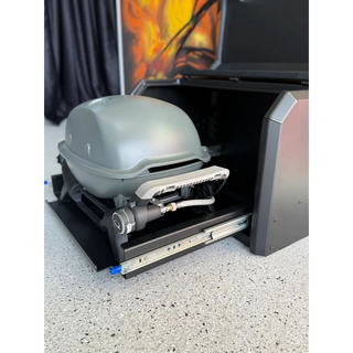 Thorburns BBQ 2.0 Accessory – portable grill with a hose attached inside an open toolbox on a concrete surface.