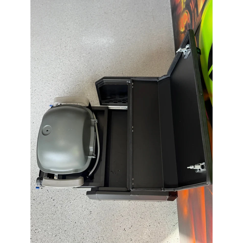 Thorburns BBQ 2.0 Accessory – grey and black grill on a white surface with a colourful object partially visible