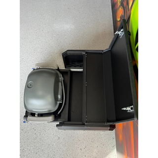 Thorburns BBQ 2.0 Accessory – grey and black grill on a white surface with a colourful object partially visible
