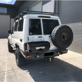 White off-road vehicle with a Thorburns LC75/78 Rear Bar mounted on a concrete surface.