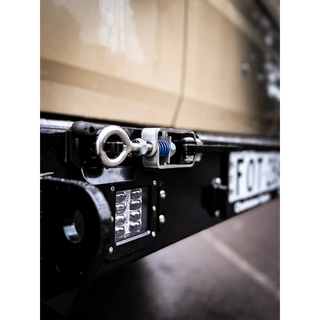 Thorburns LC75/78 Rear Bar – close-up of a vehicle's licence plate and light system with a blurred background.