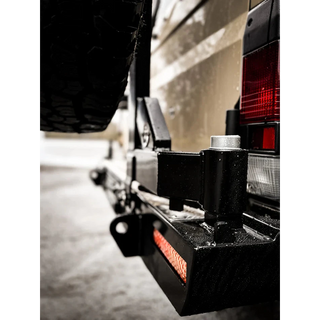 Thorburns LC75/78 Rear Bar – close-up of a vehicle's hitch and trailer attachment on a road.