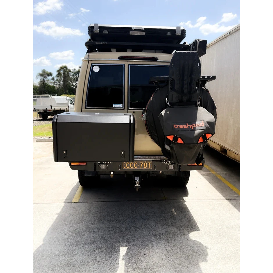 Back view of a vehicle with a spare tire and 'crashpad' branding on a concrete surface – Thorburns LC76 Rear Bar