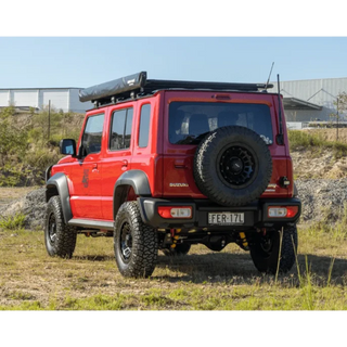 Red Suzuki Jimny XL with off-road tyres and roof rack – Torqit 2.5″ Performance Exhaust for 1.5L Suzuki Jimny XL 01/2024+