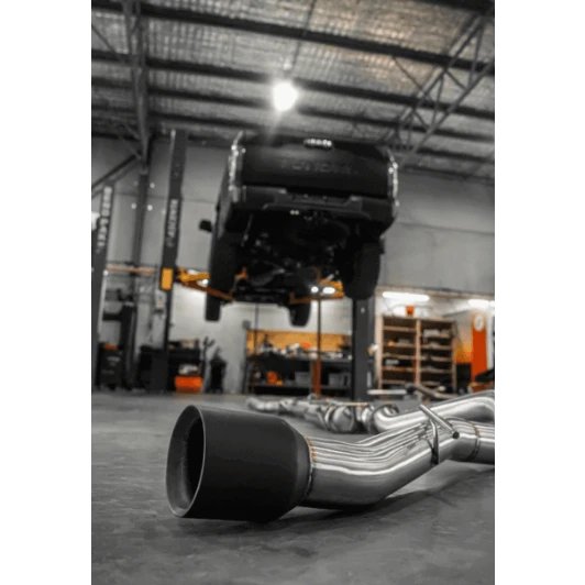 Car exhaust system on a concrete floor in a workshop – Torqit 3″ CAT Back Performance EXHAUST Toyota Tundra 3.5L V6 Petrol
