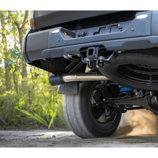Close-up of a vehicle's undercarriage with a forest background – Torqit 3″ CAT Back Performance EXHAUST Toyota Tundra 3.5L V6 Petrol