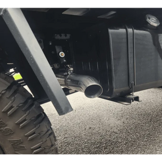 Close-up of a vehicle's exhaust system on a road – Torqit 4″ EXHAUST BRAKE Back Performance EXHAUST for Isuzu NPS Truck