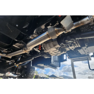 Close-up of a vehicle's undercarriage with suspension components – Torqit 4″ EXHAUST BRAKE Back Performance EXHAUST for Isuzu NPS Truck
