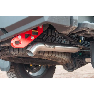 Close-up of a vehicle's exhaust system with a red component and 'Torqit' branding.