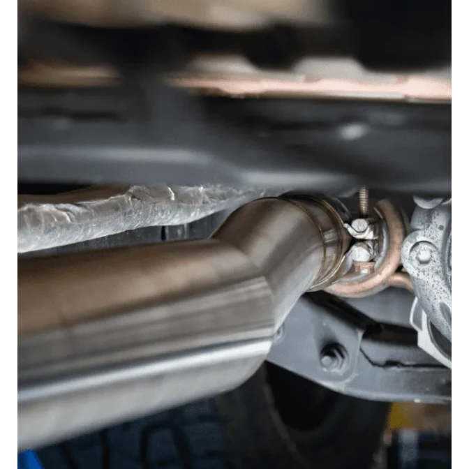 Close-up of a car exhaust system with a focus on the pipe and mounting hardware – Torqit Single Exit 3″ Cat Back Performance Exhaust for Jeep Gladiator 2020+