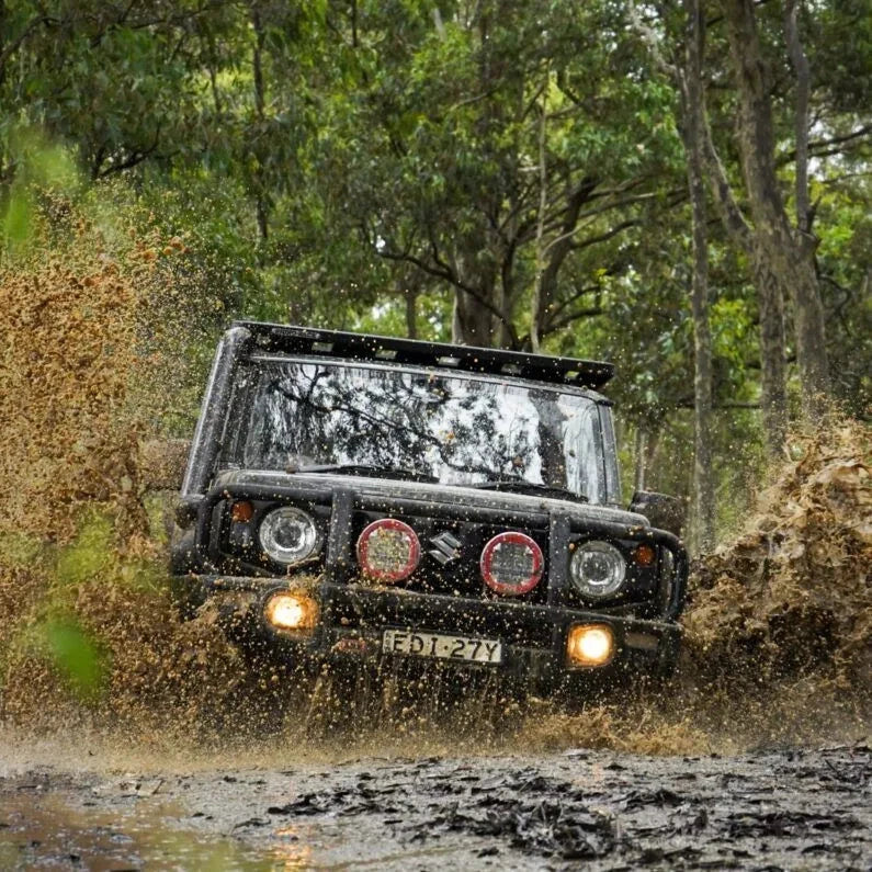 Suzuki Jimny driving through a muddy forest track – Torqit Stainless Steel Airbox (Matte Black) for Suzuki Jimny (JB74 / JC74)