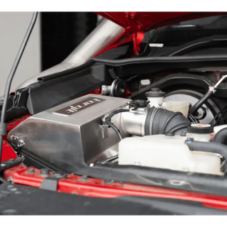 Close-up of the Torqit airbox branding in the engine bay – Torqit Stainless Steel Airbox (Matte Black) for Toyota Hilux 2.8L