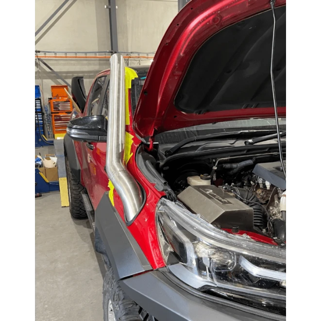 Red Toyota Hilux with bonnet open in a workshop – Torqit Stainless Steel Snorkel (Matte Black) for Toyota Hilux N80 2.8L