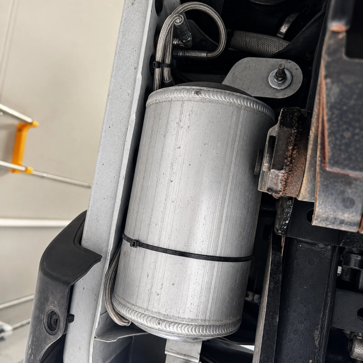Elevate stainless steel underbody bracket for the ARB Twin Air Tank on a Toyota Landcruiser 78 Series, bare 304 natural brushed finish with factory-bolt-hole mount pattern