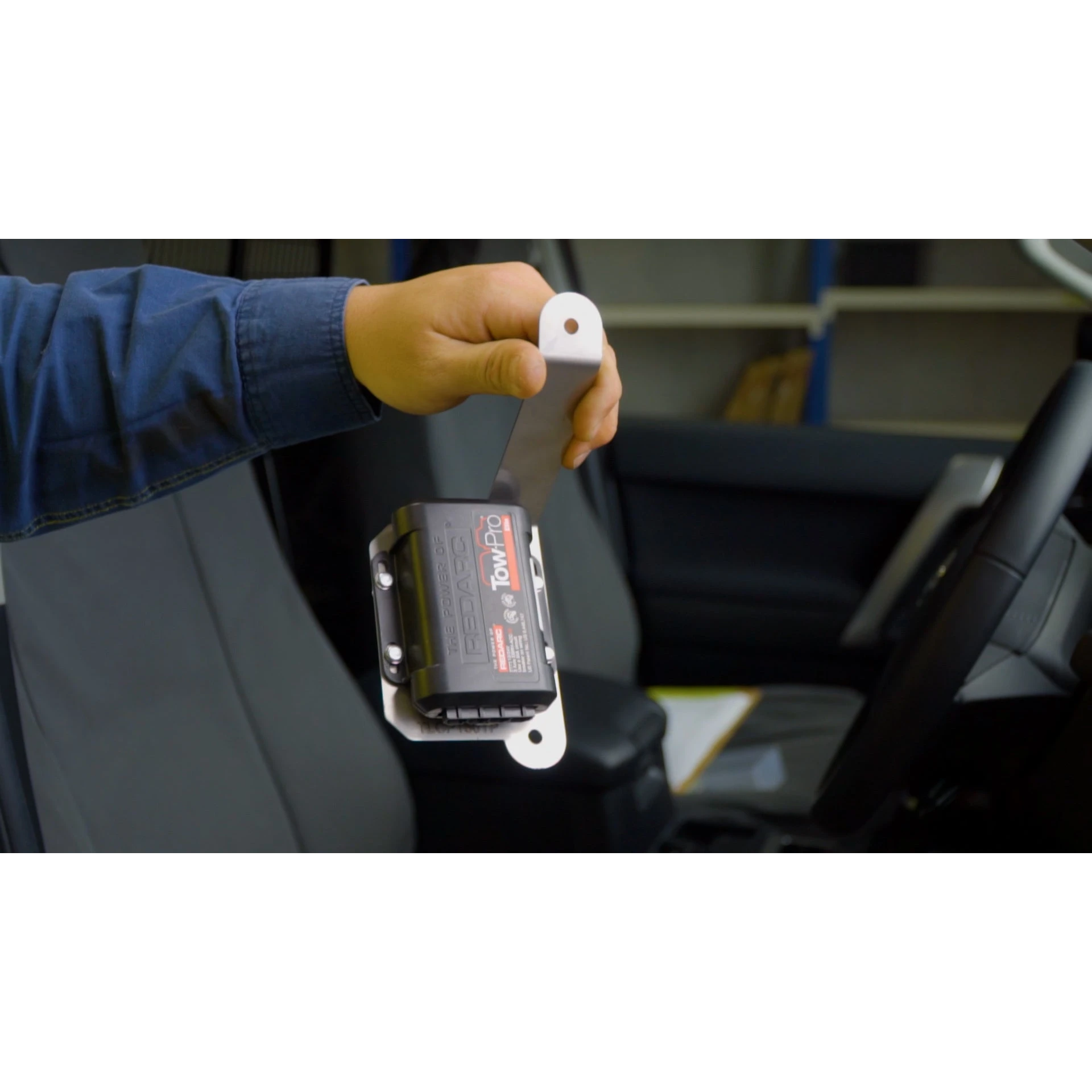 Tow-Pro Elite bracket installed behind the Toyota Prado 150 dash, bolted to factory kick-panel holes