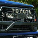 Close-up of a Toyota vehicle grille with Lazer Lamps Toyota Hilux GR Sport (2024+) Grille Kit