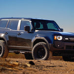 Toyota Prado 250 SUV on a dirt road with a clear blue sky