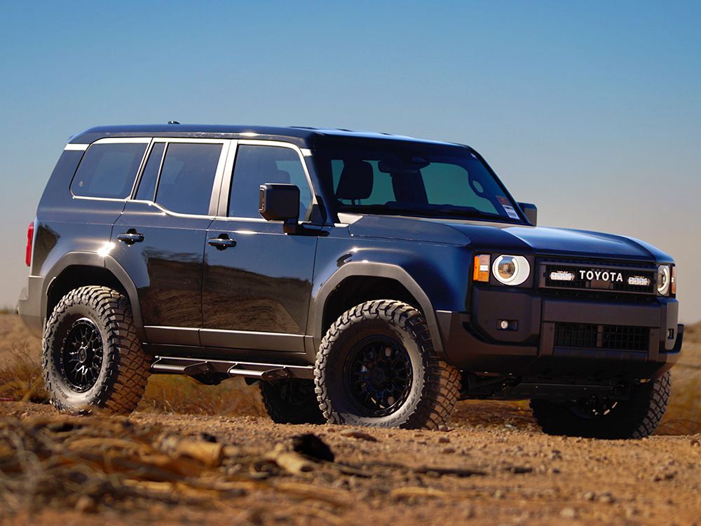 Toyota Prado 250 SUV on a dirt road with a clear blue sky