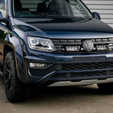 Front view of a black Volkswagen SUV parked on a concrete surface.