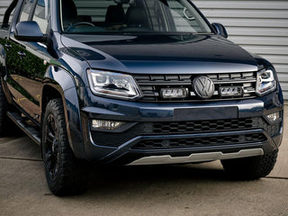 Front view of a black Volkswagen SUV parked on a concrete surface.