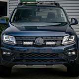 Front view of a black Volkswagen SUV with visible logo in a parking lot with Lazer Lamps Grille Kit for VW Amarok V6 (2016–2022)