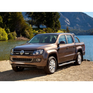 Brown Volkswagen Amarok pickup truck parked by a lake with mountains in the background with Lazer Lamps Grille Kit for VW Amarok (2011–2015)