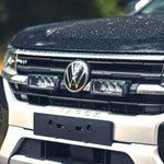 Close-up of a Volkswagen truck's front grille with logo.
