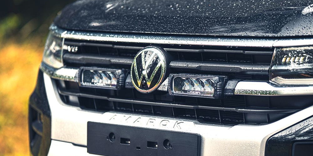 Close-up of a Volkswagen truck's front grille with logo.