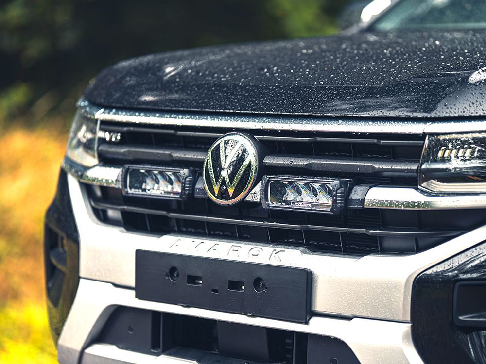 Close-up of a Volkswagen truck's front grille with logo.