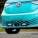 Close-up of a turquoise Volkswagen car with a blurred natural background